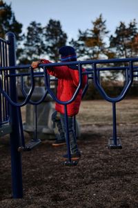 Full length of boy standing at playground during sunset