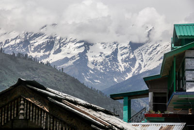 Snow covered houses against sky