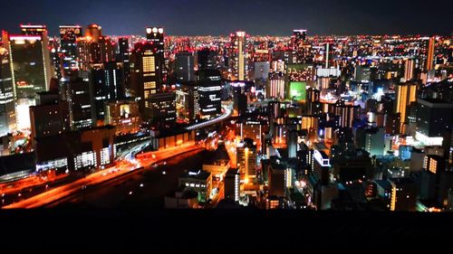 High angle view of illuminated buildings in city at night