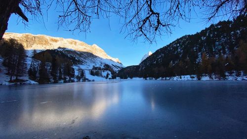 Scenic view of frozen lake against sky during winter