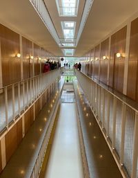 Empty corridor in illuminated building