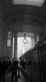 People walking in corridor of building