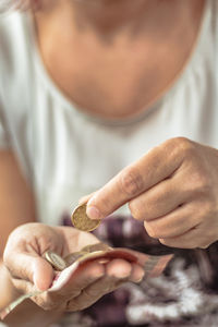 Close-up of woman holding coins