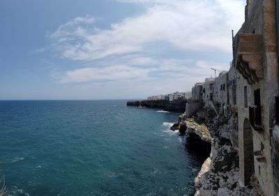 Panoramic view of sea and buildings against sky