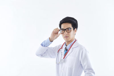 Mid adult man standing against white background