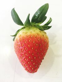 Close-up of strawberry over white background