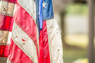 Close-up of tattered american flag outdoors