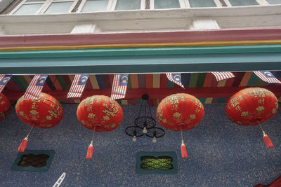 Low angle view of lanterns hanging on wall