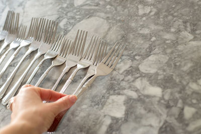 High angle view of person hand holding metal