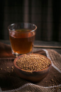 Bowl of fenugreek seeds and egyptian fenugreek yellow tea or methi dana drink