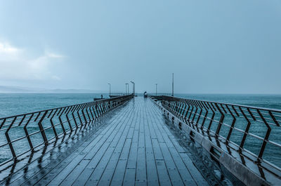 Pier over sea against sky
