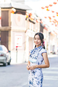 Portrait of teenager girl standing on street