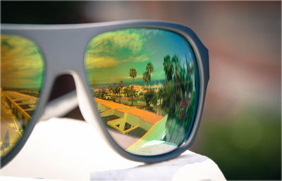 Reflection of man on side-view mirror