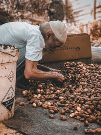 Midsection of man working in mud