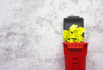 Close-up of yellow box against wall