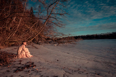 Woman on beach against sky