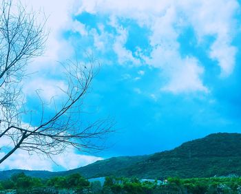 Scenic view of mountains against blue sky