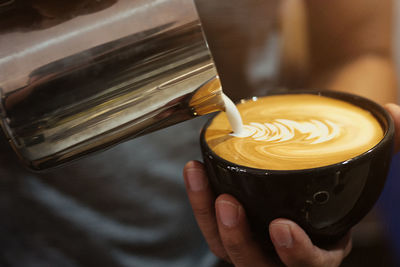 Close-up of person making coffee 