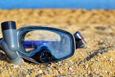 Close-up of sunglasses on beach