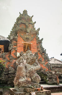 Statue of historic building against sky