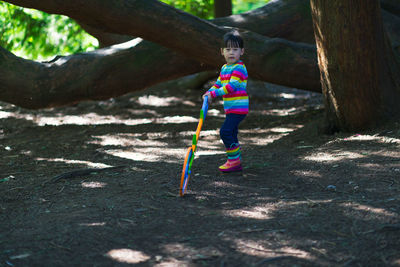 Young girl playing outdoor measure-mate in the forest park for leaning measurement