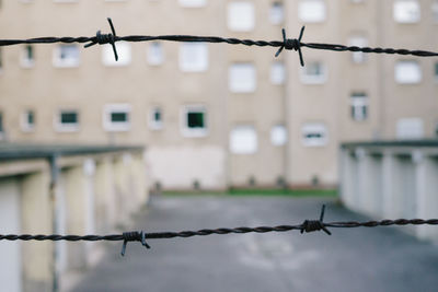 Close-up of barbed wire against sky