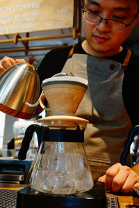 Barista making coffee in cafe