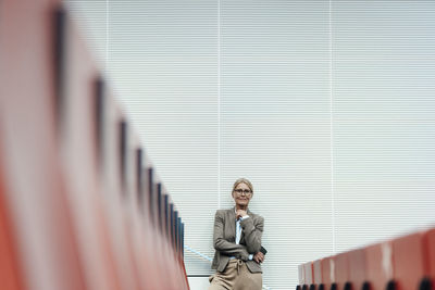 Businesswoman standing at auditorium seats