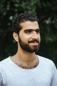 Close-up of smiling young man looking away