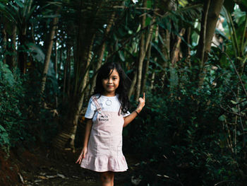 Portrait of smiling girl standing on land