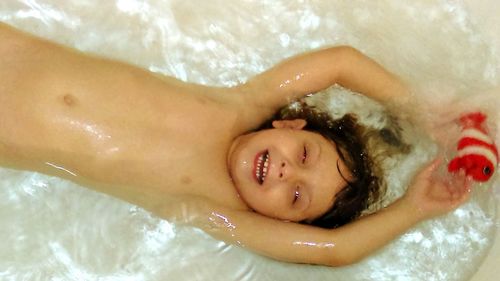 Young woman lying in water