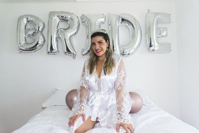 Portrait of woman against bridal decor.