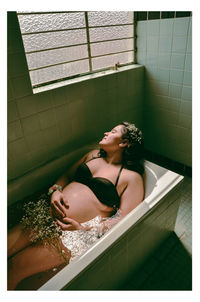 High angle view of young woman in bathroom at home