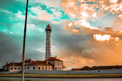 Tower in city at sunset