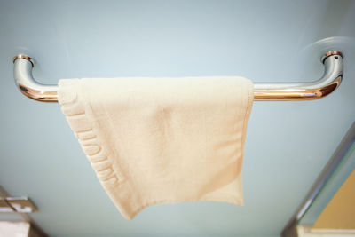 Clean white hand towel on a hanger.