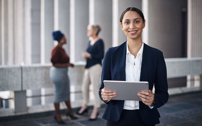 Portrait of businessman holding digital tablet in office