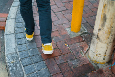 Low section of person standing on sidewalk