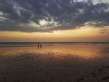 Scenic view of beach against sky during sunset