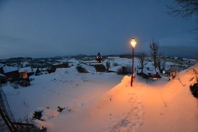 Scenic view of snow covered landscape against sky at dusk