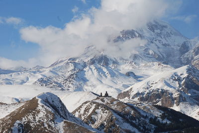 Low angle view of snow mountains against sky