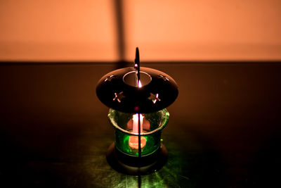 Close-up of illuminated lamp on table