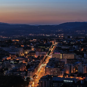 High angle view of city lit up at night