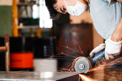 Midsection of woman working in factory