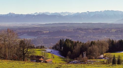 Scenic view of field and mountains against sky