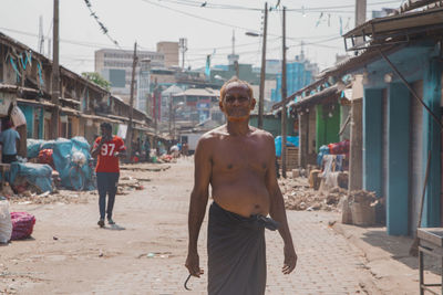 Rear view of men walking on city street