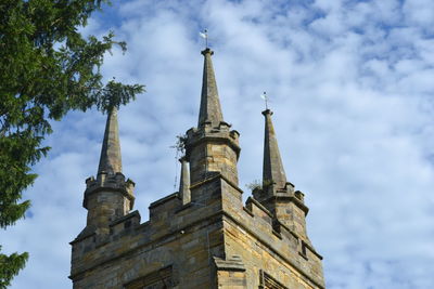 Low angle view of building against cloudy sky