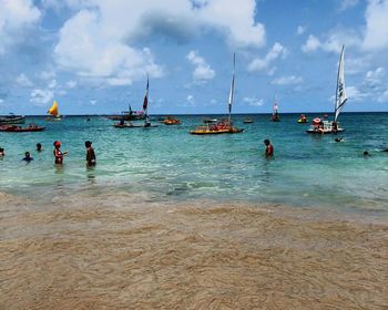 People on beach against sky