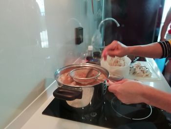 Midsection of man preparing food at home