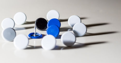 Close-up of thumbtacks on table