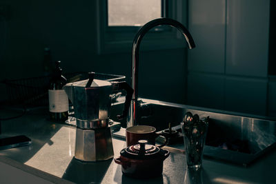 Close-up of coffee maker and cups